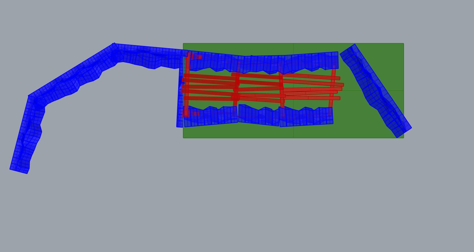 Plan view of the set model: the timber tunnel runs between two lengths of rock wall on the green deck; in plan the shaft is wider at one end and tightens along its length.