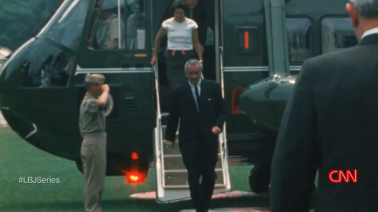 Archival footage: President Johnson stepping off a green Marine helicopter onto the lawn as a Marine salutes, with the CNN mark in the corner.